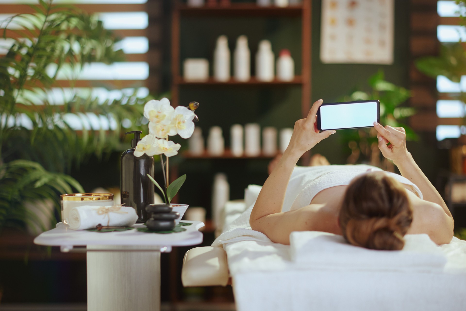 relaxed modern woman in massage cabinet laying on massage table